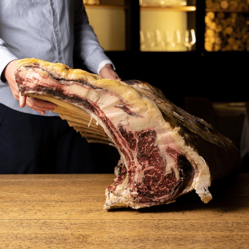 Chuletón de buey raza Minhota a la brasa sobre tabla de madera